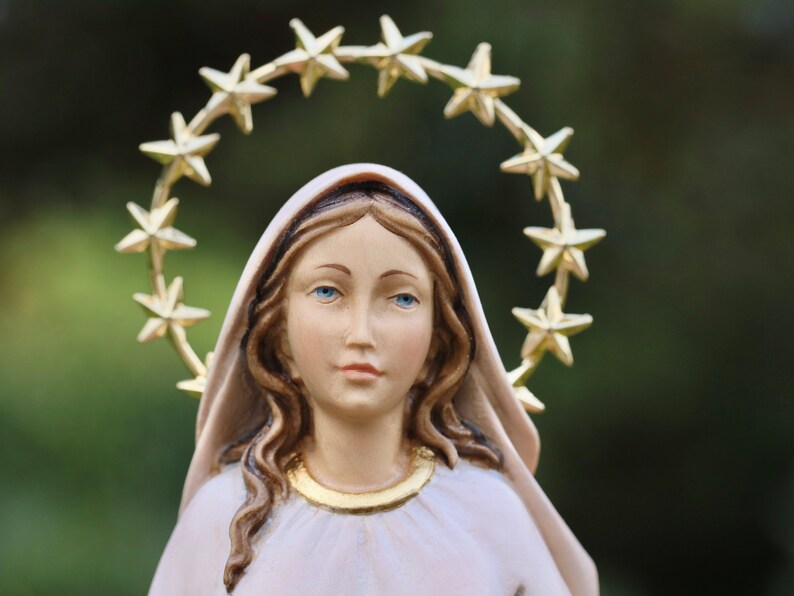 K&ouml;nnte beinhalten: Eine wei&szlig;e Figur einer Frau mit langen braunen Haaren, die einen wei&szlig;en Schleier und eine goldene Sternenkrone tr&auml;gt. Die Figur ist eine religi&ouml;se Figur.