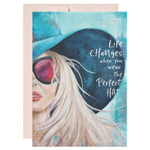 May include: A painting of a woman wearing a blue and black hat with red sunglasses. The text "Life Changes when you wear the Perfect Hat" is written on the image.