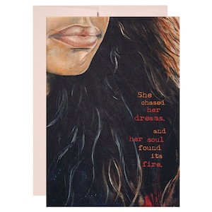 May include: A painting of a woman's face with long dark hair. The text "She chased her dreams, and her soul found its fire." is written in red and yellow on the right side of the image.