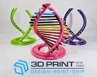 May include: A pink, green, and purple pencil holder in a DNA helix design. The pink holder is filled with colored pencils. The green and purple holders are empty. The logo "3D PRINT NEW YORK" is at the bottom.
