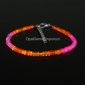 May include: A multi-coloured opal beaded bracelet with a silver clasp. The bracelet features pink, orange and yellow opal beads.