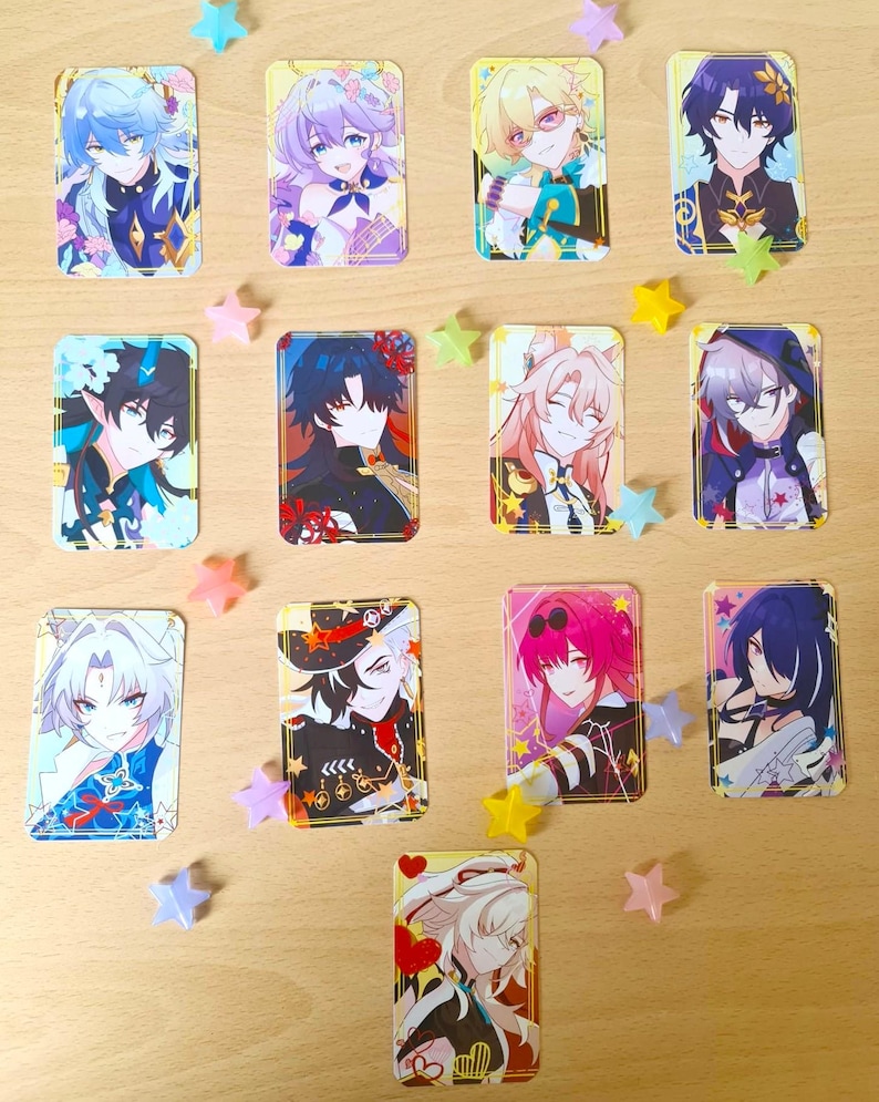 May include: A collection of rectangular anime-style character cards featuring various characters with colorful hair and outfits. The cards are decorated with star-shaped confetti in pastel colors, creating a playful and vibrant aesthetic.
