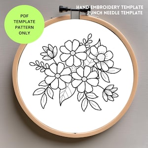 May include: Black and white line art floral design in a round embroidery hoop. The design features a cluster of flowers with five petals each, leaves, and stems.