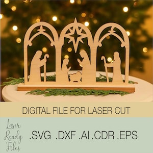 May include: A wooden Nativity scene with three arched sections, featuring silhouettes of Mary, Joseph, and baby Jesus. The central arch has a star. The base includes the text "DIGITAL FILE FOR LASER CUT" and file type extensions.