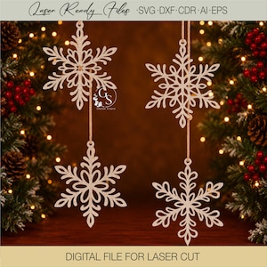 May include: Four light-colored wooden snowflake ornaments hanging from thin strings. Each snowflake features a detailed, intricate laser-cut design with symmetrical branches. The text Laser Ready Files SVG DXF CDR AI EPS and DIGITAL FILE FOR LASER CUT is visible.