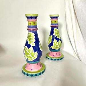 May include: A set of three ceramic mugs with a speckled, matte finish. The mugs are in shades of cream, light gray, and dark gray. Each mug has a simple, minimalist design and a rounded handle.