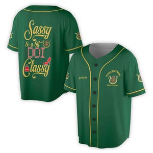 May include: Green baseball jersey with gold trim and the text "Sassy & a bit Dot Dot Dot Classy" on the front. The back of the jersey has a gold design with the text "Your Court Name" and "Your City, State".