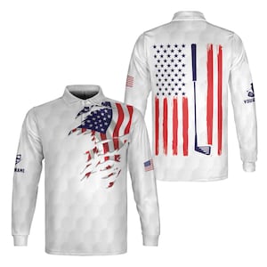 May include: White long-sleeve golf shirt with a distressed American flag design on the front and back. The back of the shirt features a golf club graphic. The shirt has a collared neckline and a honeycomb pattern.