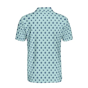May include: A light blue short-sleeved polo shirt with a repeating pattern of dark blue hand gestures.
