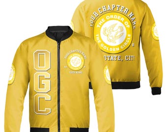 May include: A yellow bomber jacket with a black zipper and black ribbed cuffs and waistband. The jacket has a large white circle on the back with the text "The Order of the Golden Circle" and the text "Your Chapter Name" and "State, City". The front of the jacket has the text "OGC" in white letters on a yellow background.