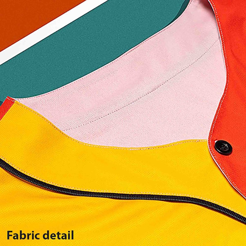 May include: Close-up of a baseball jersey with a yellow, pink, and red color block design. The jersey has a black zipper and a button on the right side.