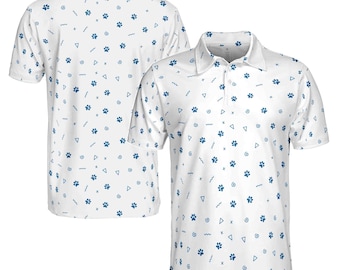 May include: White polo shirt with a blue paw print pattern and geometric shapes. The shirt has a collared neckline and short sleeves. The back of the shirt is also visible, showing the same pattern.