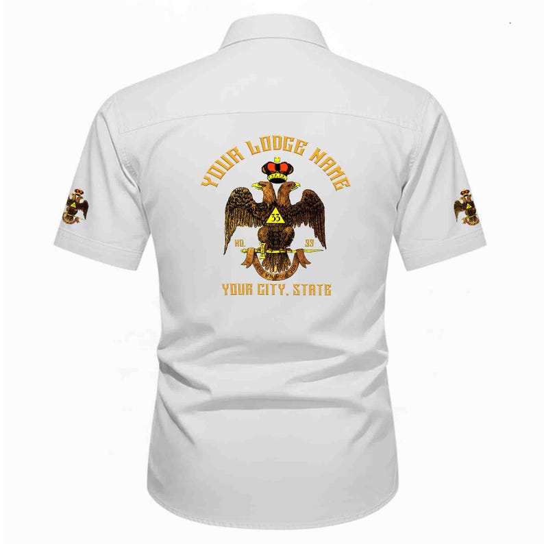 Puede incluir: Una camisa blanca de manga corta con un gr&aacute;fico en la espalda de un &aacute;guila bic&eacute;fala con corona, con el texto YOUR LODGE NAME y YOUR CITY, STATE. Las mangas presentan peque&ntilde;os emblemas de &aacute;guila a juego en cada lado.