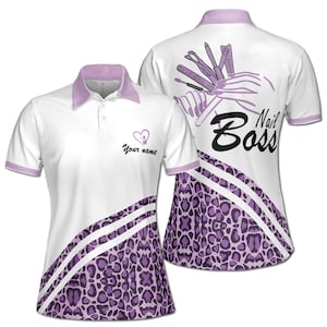 May include: White and purple women's polo shirt with a leopard print design and the text "Nail Boss" on the back. The front of the shirt has a heart with the text "Your name" on it.