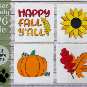 以下が含まれることがあります： 秋のテーマのレーザーカットされた木製のサインが4つ。サインには、ひまわり、かぼちゃ、秋の葉っぱ2枚、そして「Happy Fall Y'all」の文字が書かれています。