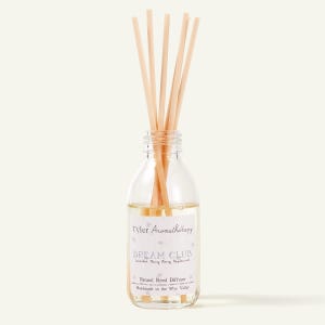 May include: A clear glass aromatherapy diffuser bottle with wooden reeds. The bottle contains a light-coloured liquid and a label that reads "Tyler Aromatherapy DREAM CLUB". The label also states "Natural Reed Diffuser".