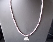 Wampum Cebu shell necklace with sterling silver pendant.