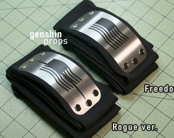 May include: Two black headbands with silver metal plates. The plates have a stylized design with vertical lines. The text "Freedom ver." and "Rogue ver." are visible. The background is a green grid.