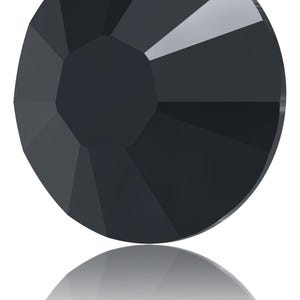 May include: A faceted, round, black gemstone with a reflective surface. The gem has a central, flat facet surrounded by multiple triangular facets, creating a geometric design. The gem's reflection is visible below it.