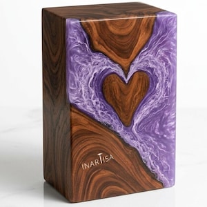May include: A rectangular wooden box with a heart-shaped design. The box features a combination of dark brown wood and a swirling purple resin. The heart is formed by the wood grain. The text "INARTISA" is visible on the side.