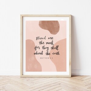 May include: A printable wall art print with a pink background and abstract brown shapes. The print features the Bible verse "Blessed are the meek, for they shall inherit the earth" from Matthew 5:5.