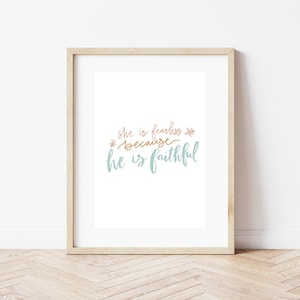 May include: A framed print with a white background and the text "She is fearless because he is faithful" in blue and pink lettering with a floral design.