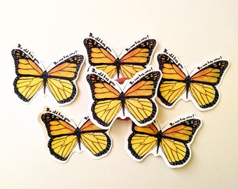 May include: A collection of butterfly stickers with yellow and orange wings and black outlines. Each sticker has the text "The old has gone. The new has come!" in black script. The stickers are arranged on a white surface.