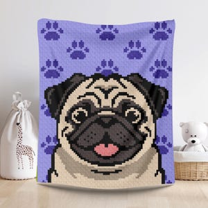 May include: A pixelated pug dog design on a lavender blanket. The blanket features a repeating pattern of dark purple paw prints. The pug has a tan face, black ears, and a dark gray snout. The blanket is displayed in a room with a white background.