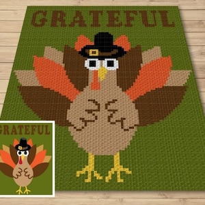 May include: A green crochet blanket with a brown and orange turkey design. The turkey is wearing a black hat and has the word "GRATEFUL" written above it. The blanket also has a smaller version of the turkey design in the bottom left corner.
