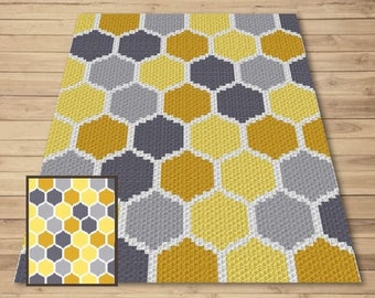 May include: A crocheted rug with a honeycomb pattern in shades of yellow and gray.