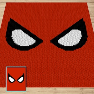 May include: A red crochet blanket with a black and white pixelated image of Spider-Man's eyes. The image is in the center of the blanket. A smaller version of the image is in the lower left corner of the blanket.