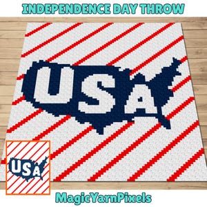 May include: A square throw blanket featuring a white background with diagonal red stripes. In the centre, a dark blue silhouette of the United States map contains the white letters USA. The design has a pixelated, grid-like texture throughout.