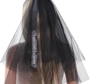 May include: Black bridal veil with a black satin ribbon bow and the text "I DO! I DID. I'M DONE." printed on the ribbon.