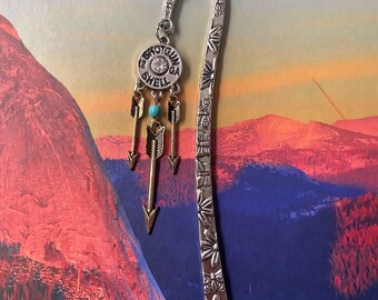 Shotgun shell with dangling arrows bookmark