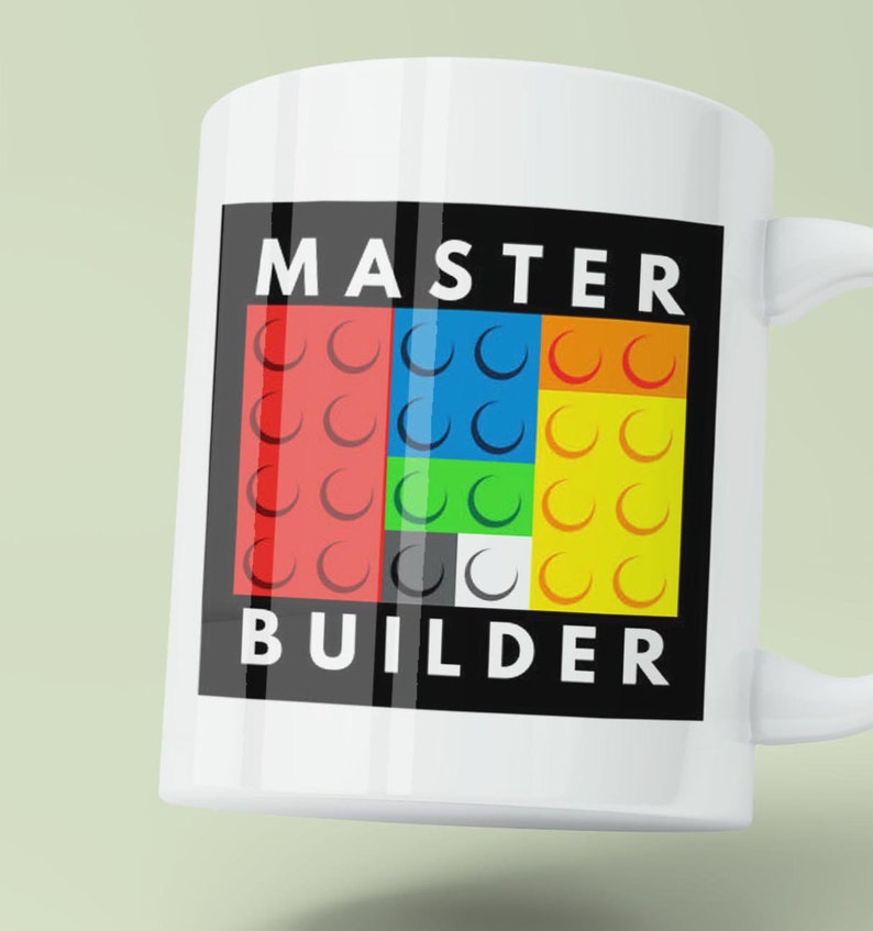 May include: White ceramic mug with a black square design featuring the text "MASTER BUILDER" in white letters. The square also contains a colorful pattern of red, blue, green, yellow, black, and white Lego bricks.