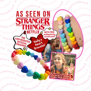 May include: A heart-shaped bead bracelet in a rainbow of colours, inspired by Stranger Things. The bracelet features red, orange, yellow, green, blue, and purple hearts. The text "AS SEEN ON STRANGER THINGS" is also visible.