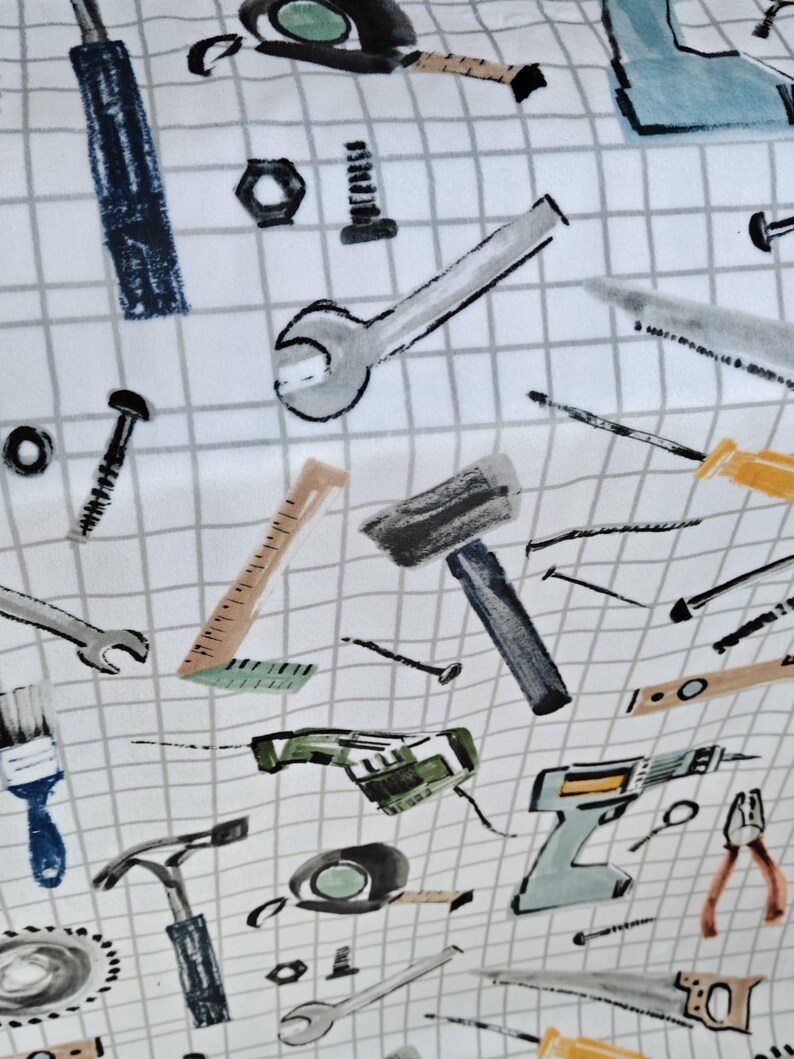 May include: White fabric with a grid pattern featuring illustrations of various tools, including wrenches, hammers, saws, and drills. The tools are in shades of gray, blue, and yellow.
