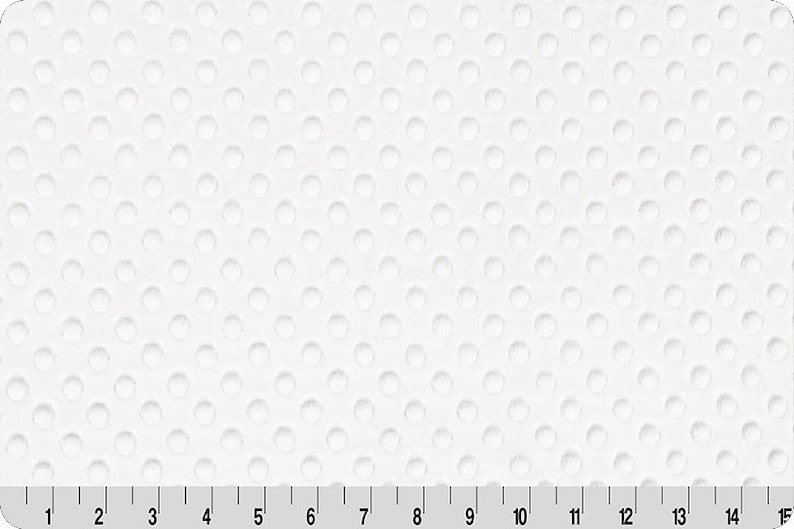 Puede incluir: Tela blanca con un patr&oacute;n repetitivo de peque&ntilde;os c&iacute;rculos en relieve.