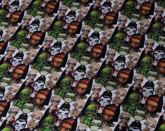 May include: A white fabric with a repeating pattern of black and white illustrations of various monster characters. The characters include Frankenstein's monster, Dracula, the Creature from the Black Lagoon, and a werewolf.