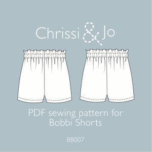 May include: A sewing pattern for Bobbi Shorts, a PDF download from Chrissi & Jo. The pattern includes two views of the shorts, one with a front view and one with a back view. The pattern is for a pair of shorts with an elastic waistband.