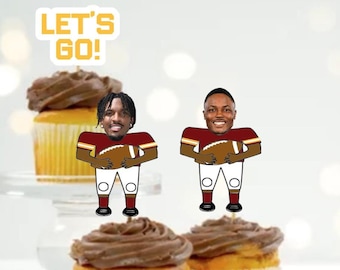 May include: Two cupcake toppers featuring football players wearing red and gold uniforms. The toppers are holding footballs and have the text "Let's Go!" on top.