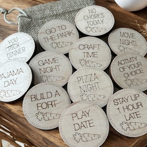 May include: A set of 12 wooden tokens with various activities written on them, such as "Go to the Park", "Game Night", "Pizza Night", and "Stay Up 1 Hour Late". Each token features a small carrot illustration.