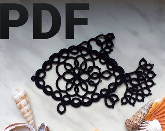 May include: Black tatting pattern in the shape of a fish with a floral design. The pattern is on a white marble surface with seashells.