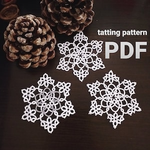 May include: Three white crocheted snowflakes on a dark brown wooden surface. The text "tatting pattern PDF" is in the upper right corner of the image.
