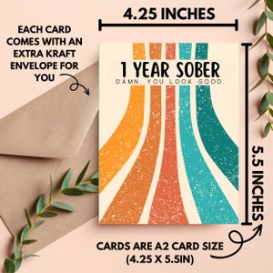 May include: A greeting card with a retro rainbow design and the text "1 Year Sober. Damn. You look good." The card is 4.25 inches by 5.5 inches.