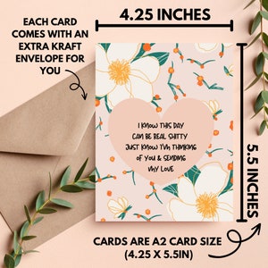 May include: A2 card (4.25 x 5.5 inches) with a floral design and a heart-shaped message: "I know this day can be real shitty, just know I'm thinking of you & sending my love." Includes a kraft envelope.