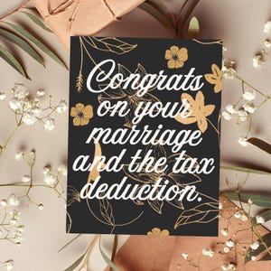May include: A black card with gold floral designs and the text "Congrats on your marriage and the tax deduction."