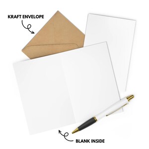 May include: A blank greeting card with a kraft envelope and a black pen. The card is folded in half and the envelope is open. The text "BLANK INSIDE" is written on the card.