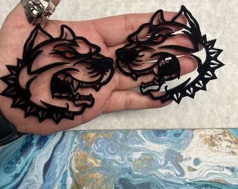 May include: Two black and red detailed dog head stickers with a spiked collar design.