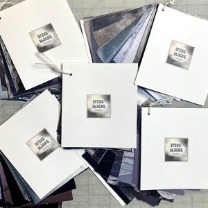 Magazine collage paper; Pre-sorted colors – Grays and Blacks. Flip & Find® the perfect piece. National Geographic